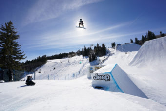 Jamie anderson taking the big air gold at x games 2021, covering the sun