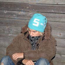 turkos med fl&auml;ta och texten: S-N.