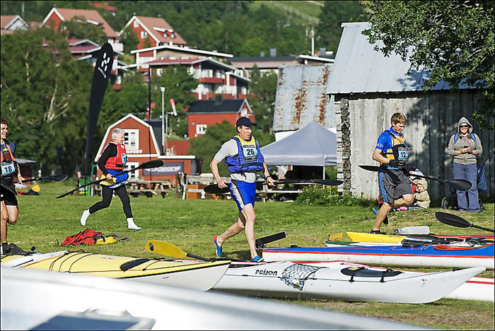 Alla springer till sina kajaker som ligger på strandkanten. Nummer 26 vann tävlingen.
