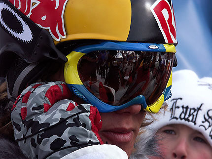 Jon Olsson pratar i telefon och skriver autografer samtidigt.